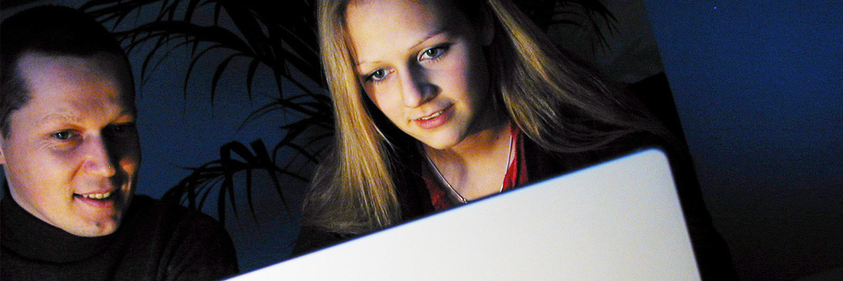 two students looking at larger computer monitor