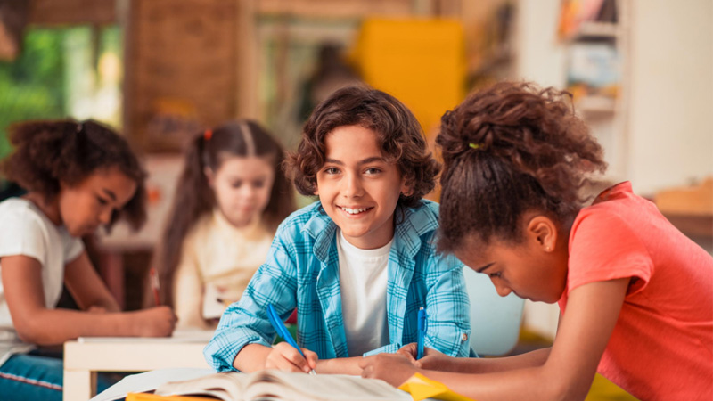 smiling students doing school work