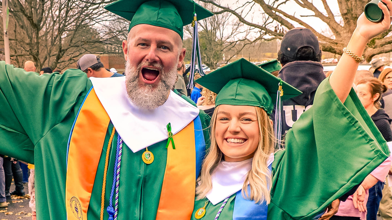 Two smiling graduates