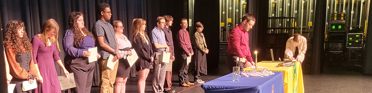 Sigma Kappa Delta on stage receiving awards