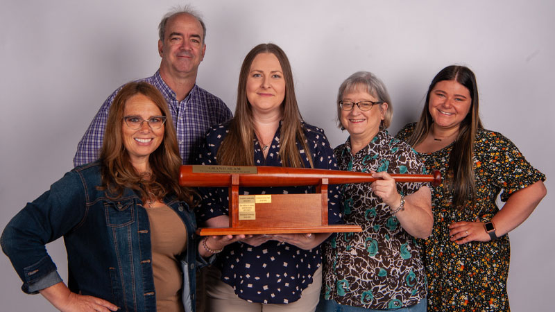 Communications team with grand slam award