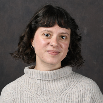 Profile photo of Kait McCloskey, Disability Resource Center Accommodations Coordinator, in front of a professional backdrop.