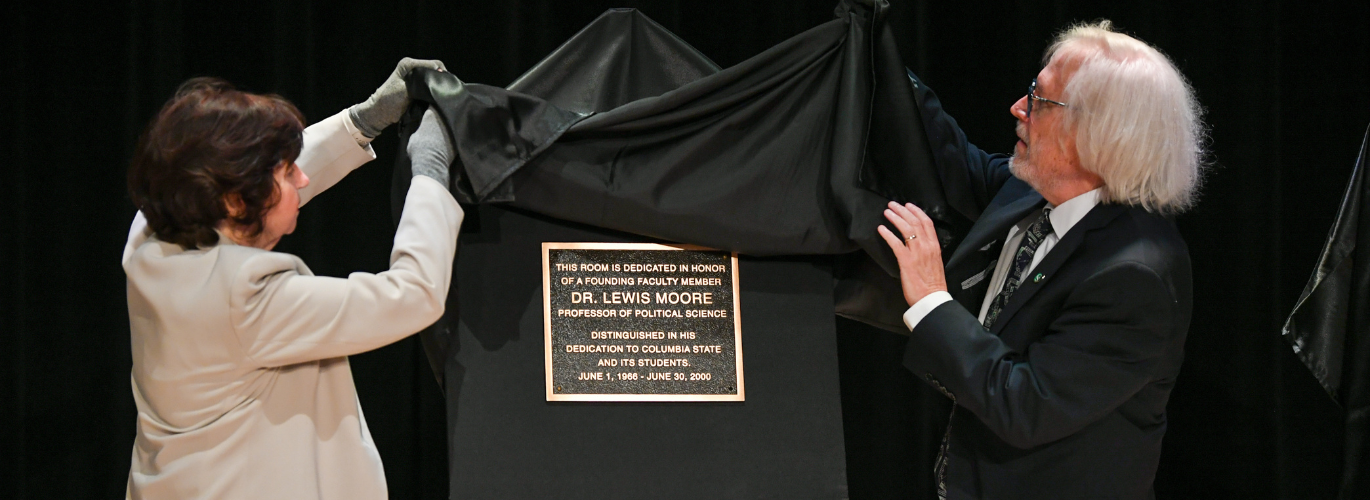 Dr. Janet F. Smith, Columbia State president, and Dr. Barry Gidcomb, Columbia State professor of history, unveil the new Clement building founding faculty room dedication plaques.