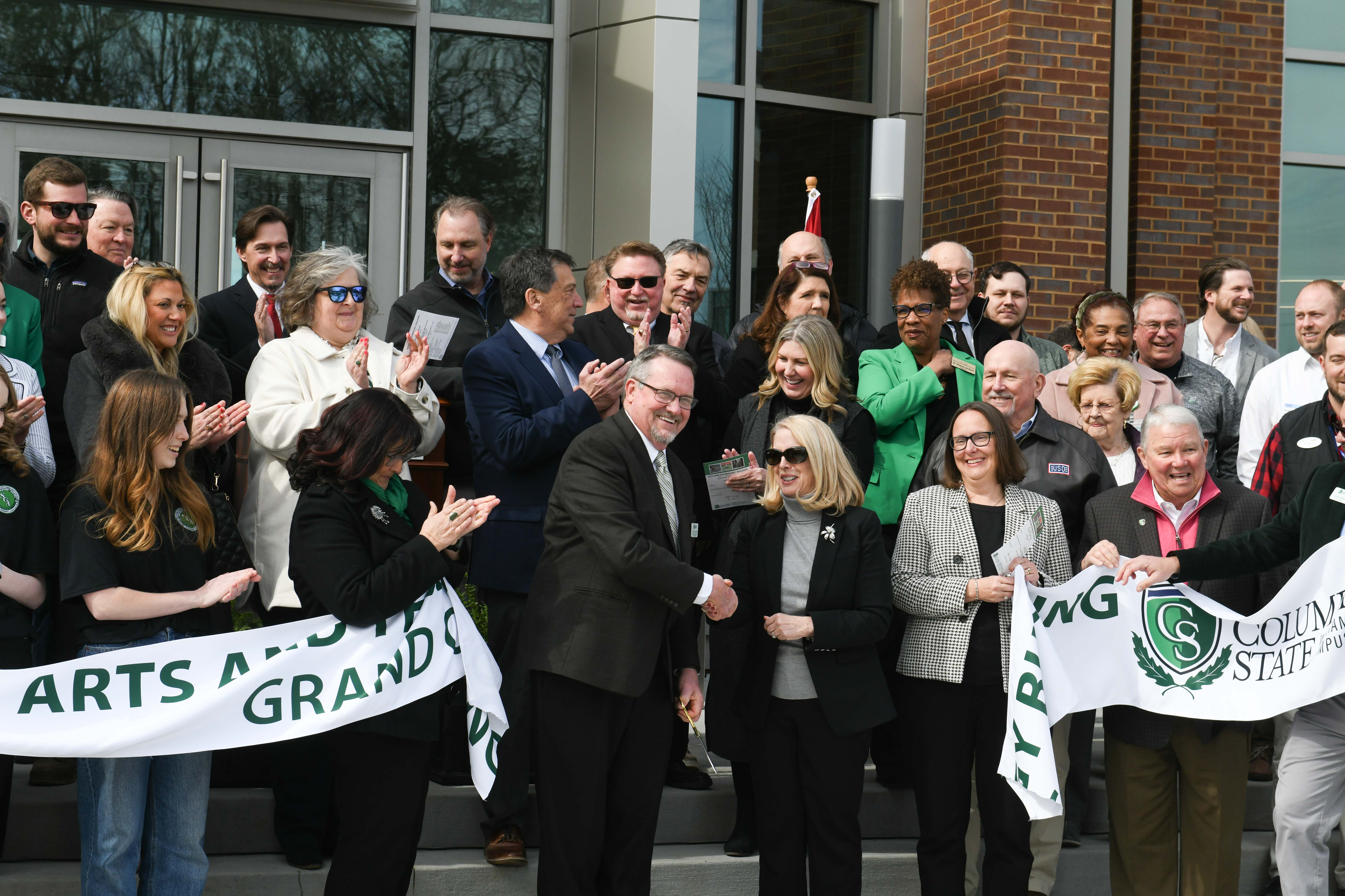 Dr. Dearl Lampley, Columbia State vice president of the Williamson Campus and external services, shakes hands with Dr. Flora W. Tydings, Tennessee Board of Regents chancellor, after cutting the ribbon for Columbia State’s new arts and technology building on the Williamson Campus.