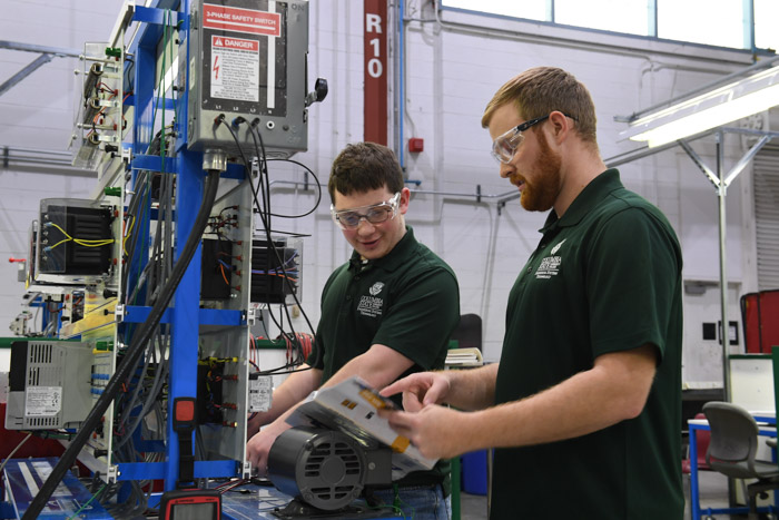 Students work on a robotic arm at Columbia State.