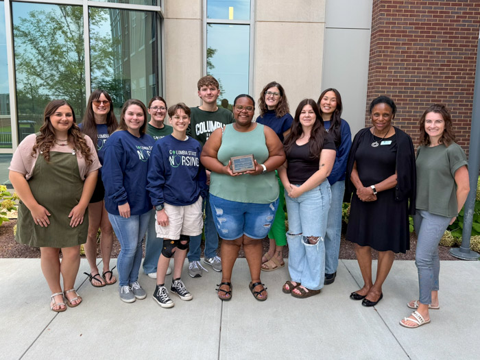 Columbia State students and faculty receive the NSNA Stellar School Chapter designation and award plaque. Pictured (front row, left to right): Lovie Curtis; Michelle Simmons; Grace Delabruere; Lauren Gilbert; and Leah Ashworth. Back row, left to right: Hassie Bigbie; Jennifer Scribner; Jedediah Roberts; Dr. Michele Marbet, Columbia State assistant professor of nursing and SNA advisor; Rachel Hanna; Dr. Loretta Bond, Columbia State program director and associate professor of nursing; and Shania Dubbert, Columbia State instructor of nursing.