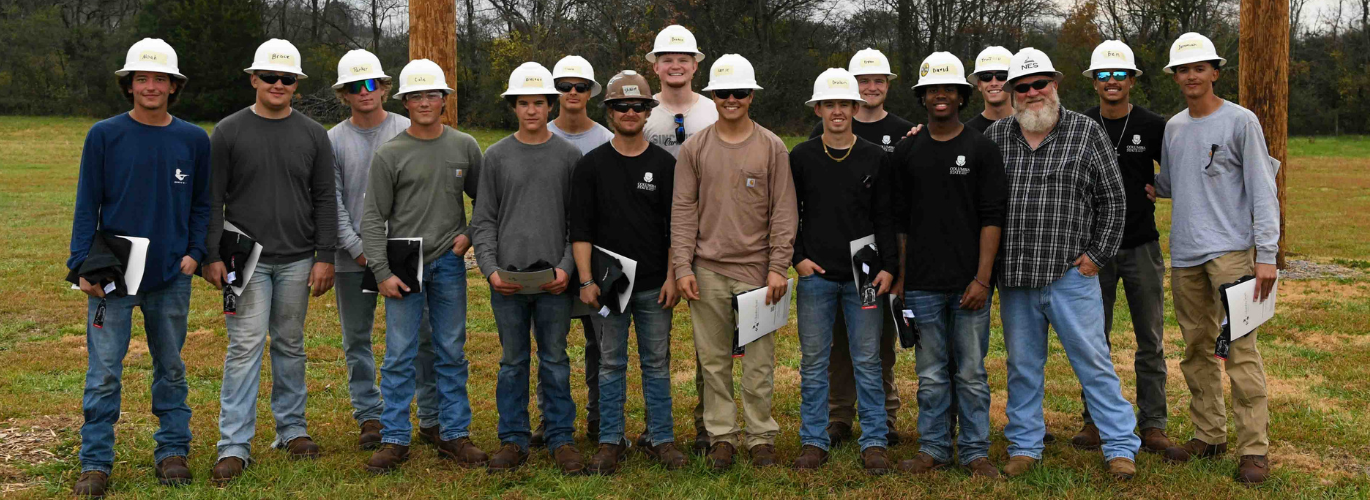 A group photo shows the graduating cohort of lineworkers for the Fall 2025 semester.
