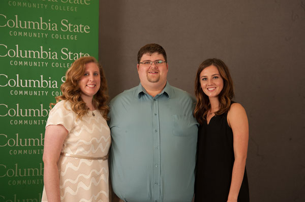 two girls and a guy smile