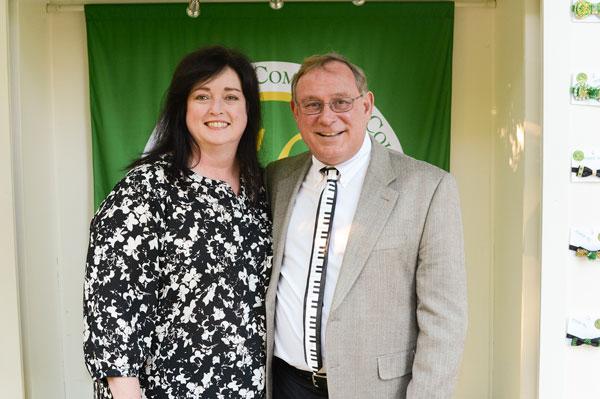 Dark haired woman and man with glasses