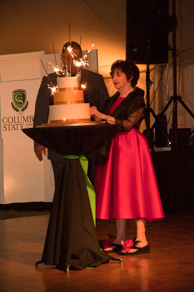 Man and woman cutting cake