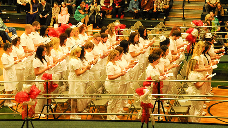 Nursing graduates holding candles