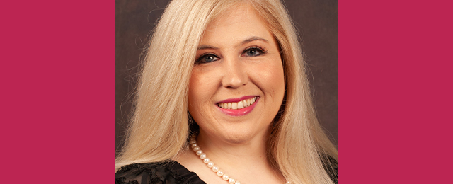 Profile photo of Melissa Febbroriello, a Director Student Mental Health and Wellbeing, in front of a professional backdrop