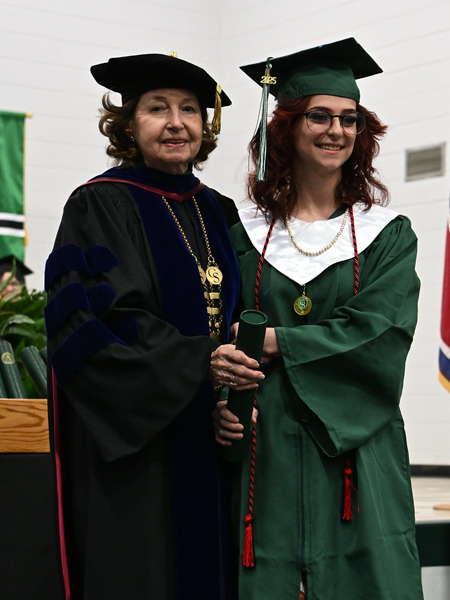 student shaking hands with president smith