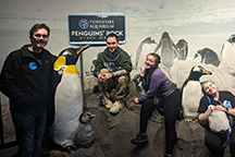 Group of students with penguin display