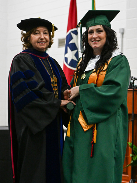 student shaking hands with president smith